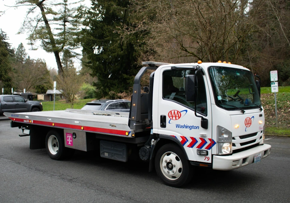 A tow truck is driving on a street